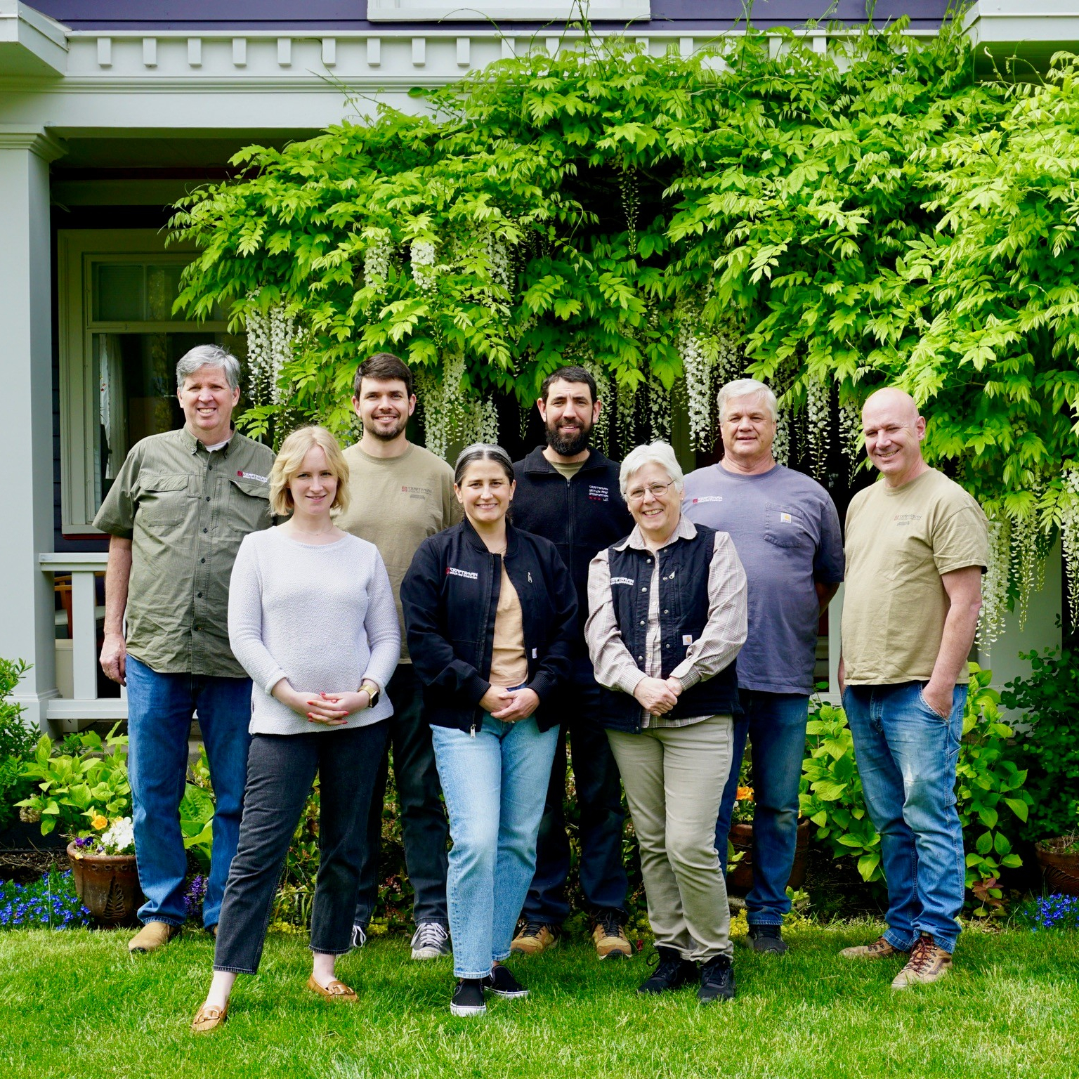 team homepage Craftsman Design and Renovation team in front of a vintage Portland, Oregon home with newly rebuilt porch