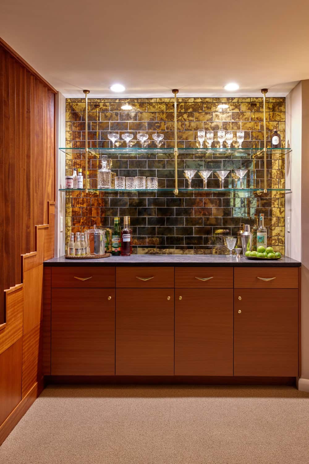 Mid century inspired bar with gold tile, walnut cabinets.